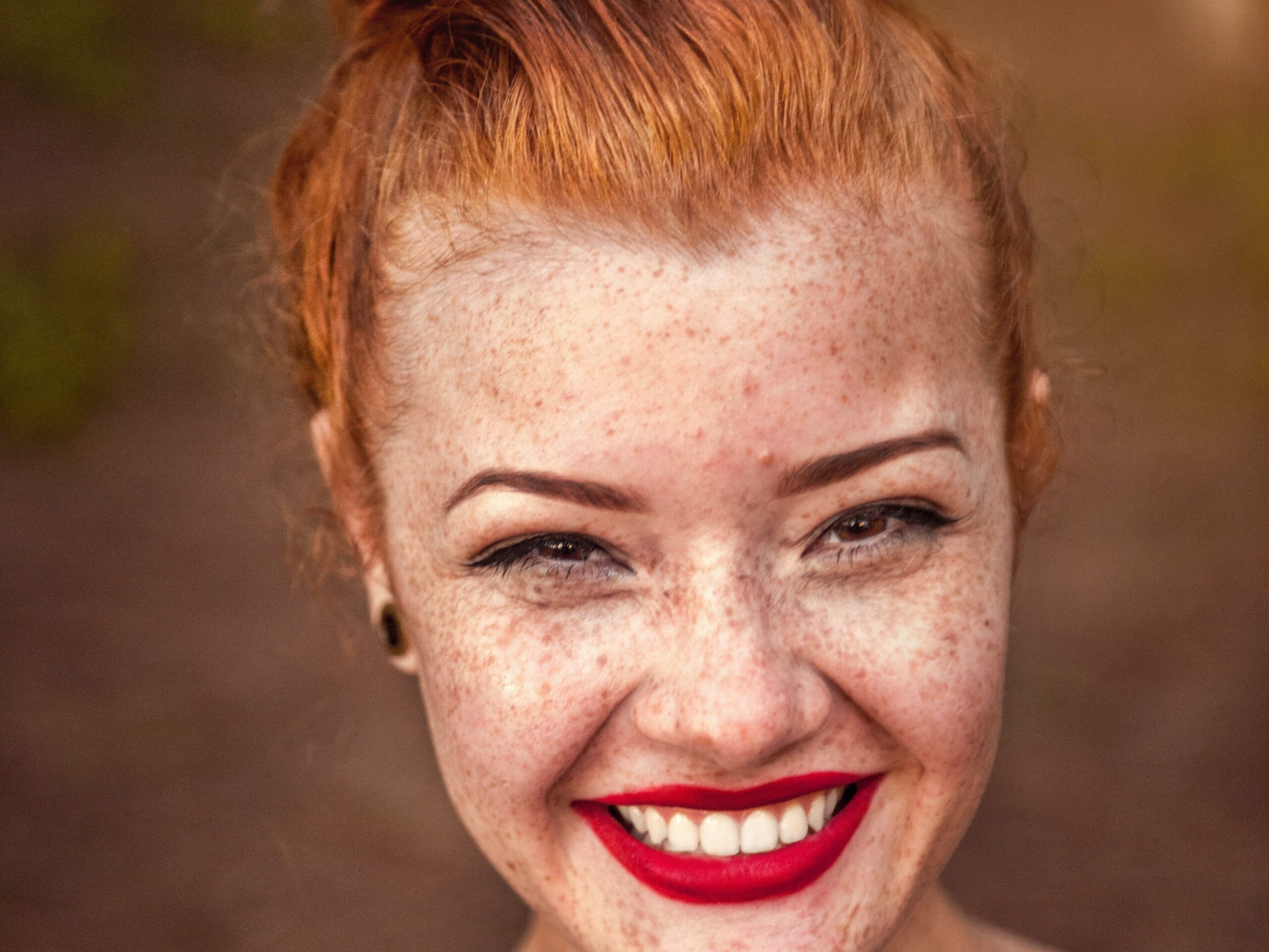 woman taking photo while showing smile